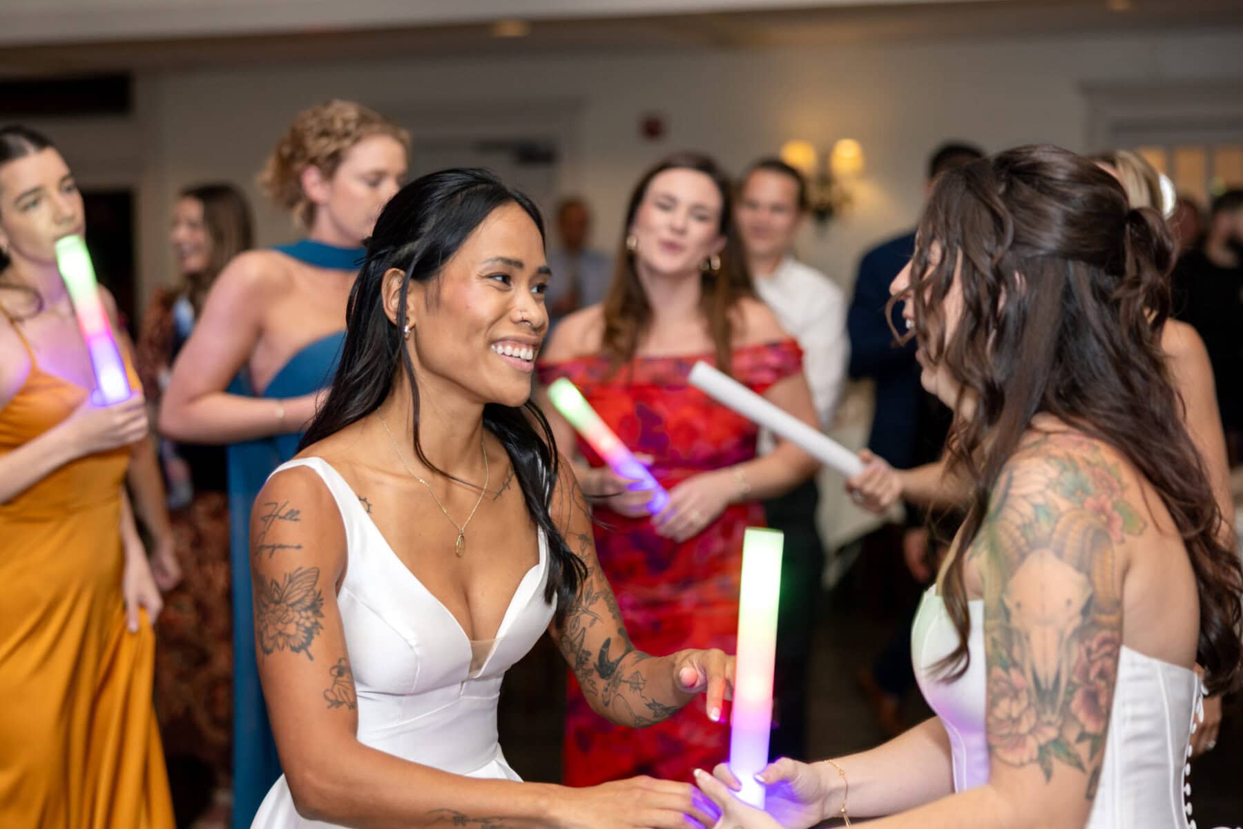 Wedding Reception at the Barker House 29 A group of women holding light sticks at a lively Barker House wedding reception.