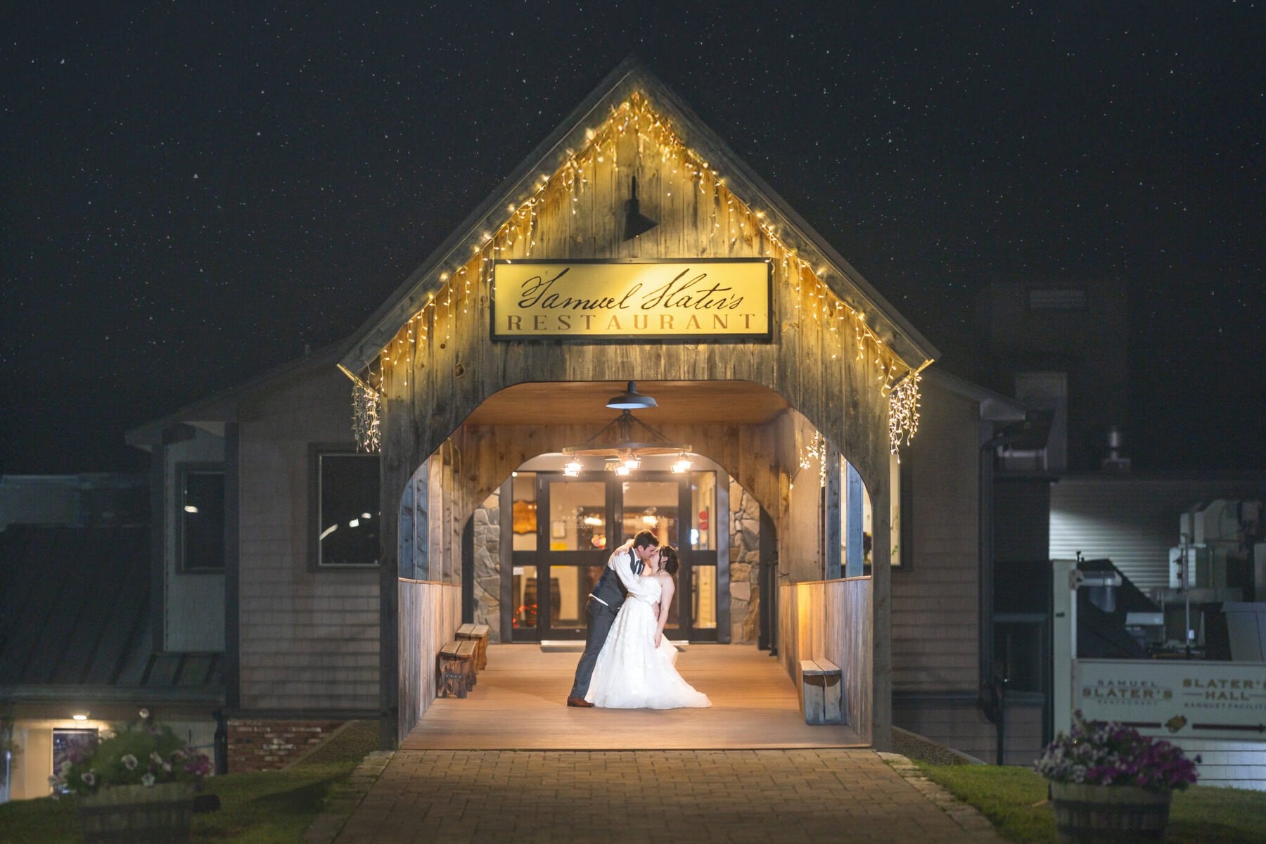 Stunning Wedding at Indian Ranch and Samuel Slater's Restaurant 111 A bride and groom share a wedding dance under string lights outside Samuel Slater's Restaurant at Indian Ranch.