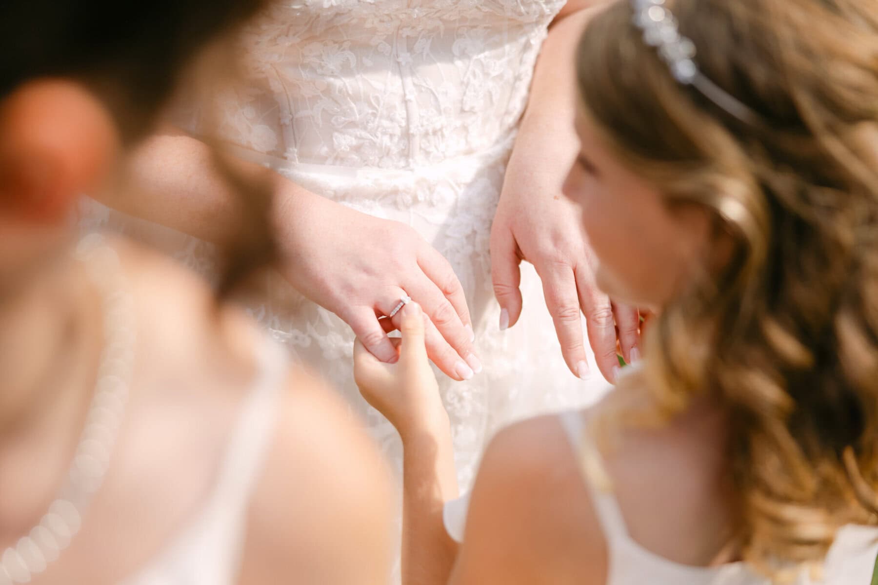 Wedding At the Holliston Historical Society 29 Close-up of a child placing a ring on someone’s finger in lace at a wedding, taken at the Holliston Historical Society wedding venue.