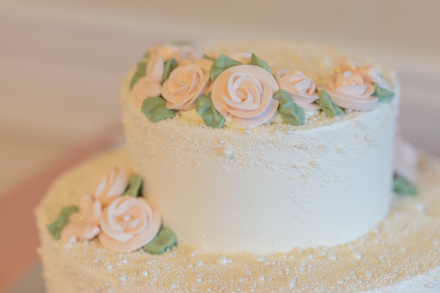 Beautiful Lake Pearl Wedding in Wrentham, MA 23 A white frosted cake decorated with light pink icing roses, perfect for a Lake Pearl Wedding in Wrentham MA.