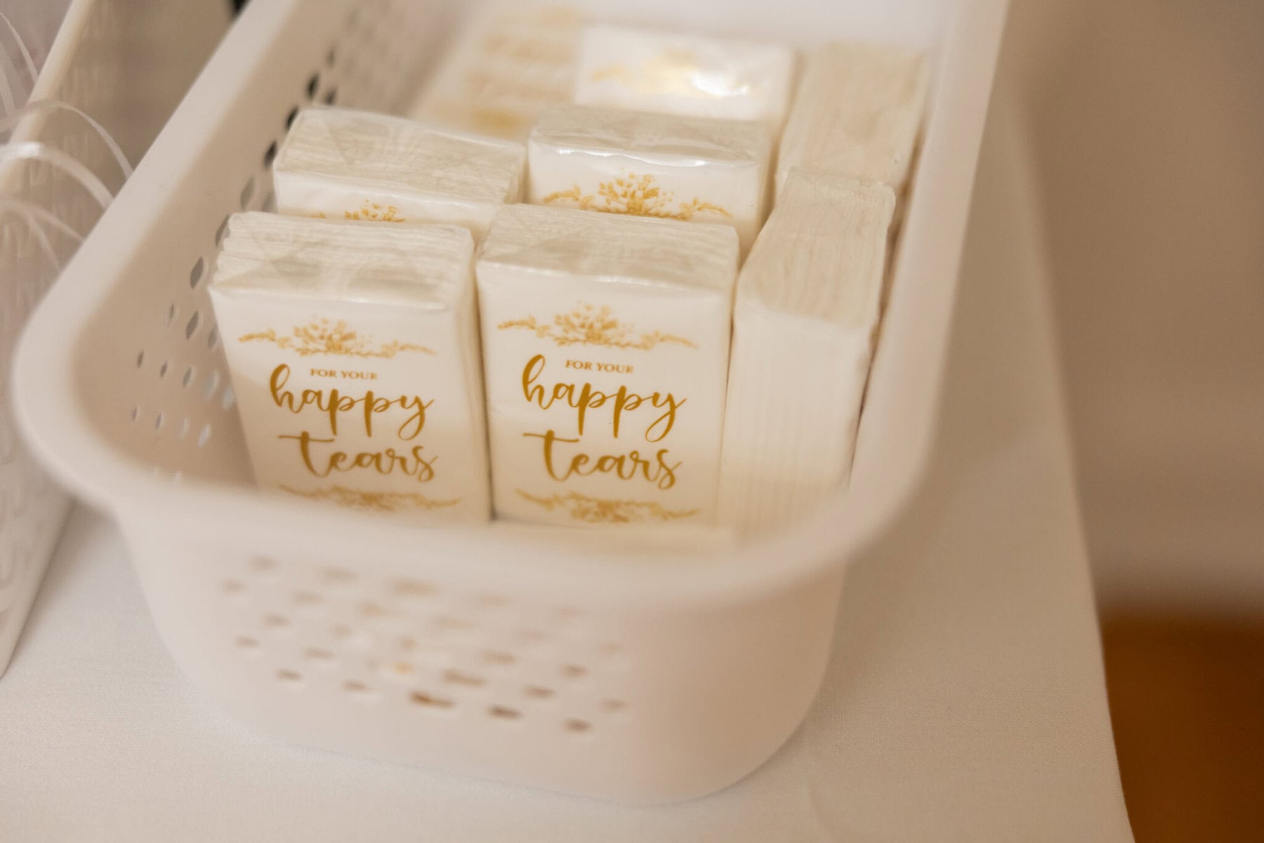 Beautiful Lake Pearl Wedding in Wrentham, MA 29 A white basket at this Lake Pearl Wedding in Wrentham, MA holds packets of tissues labeled "For your happy tears" and plain white napkins.