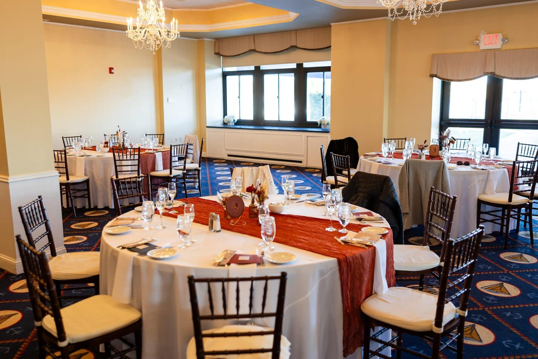 Wedding at the Newport Naval Station Officers' Club 66 Round tables with place settings fill the elegant Officers' Club at Newport Naval Station, perfect for a wedding or special event.