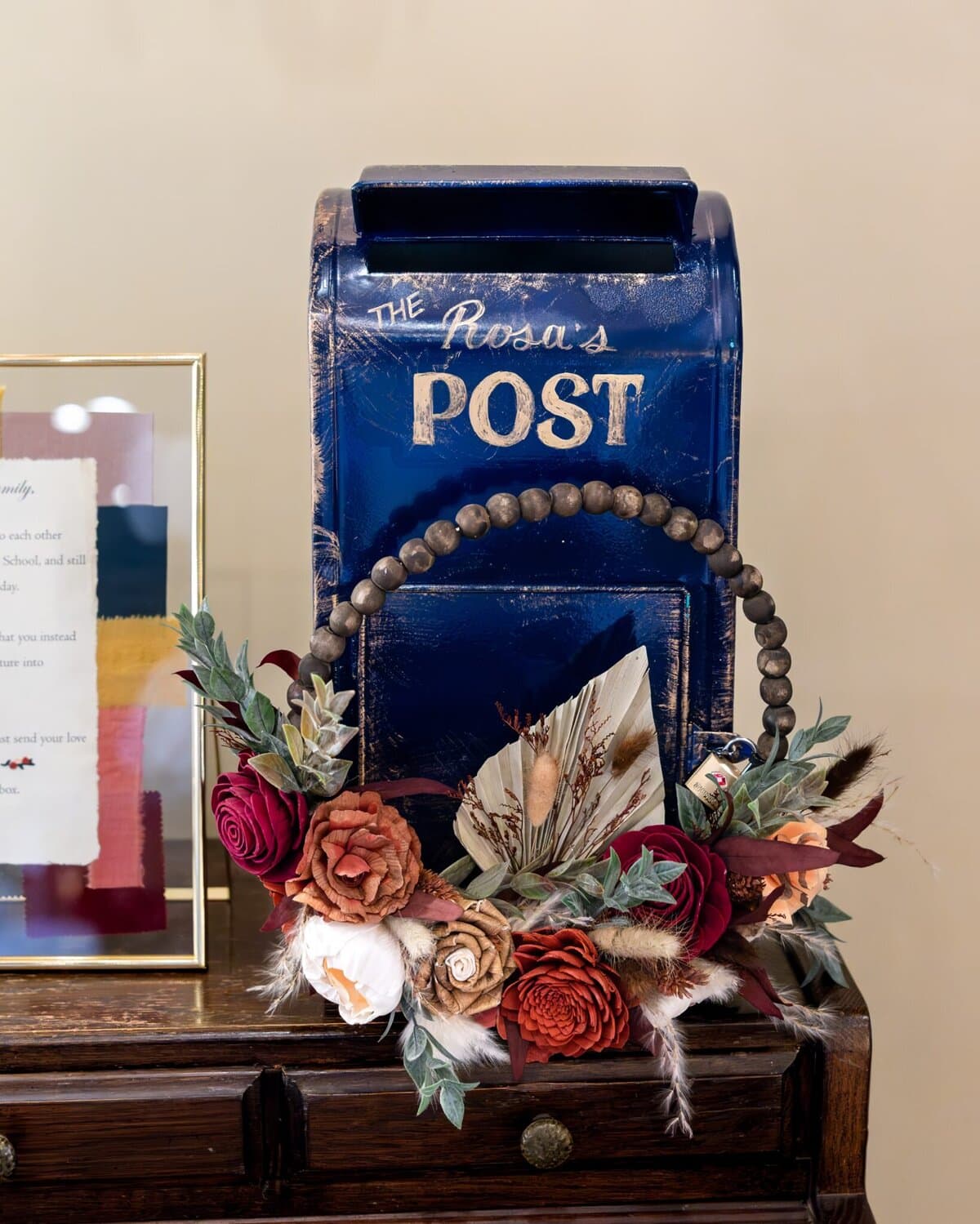 Wedding at the Newport Naval Station Officers' Club 75 A blue vintage-style mailbox labeled "The Rosa's POST" sits on a wooden table at a Newport Naval Station wedding beside a floral arrangement.