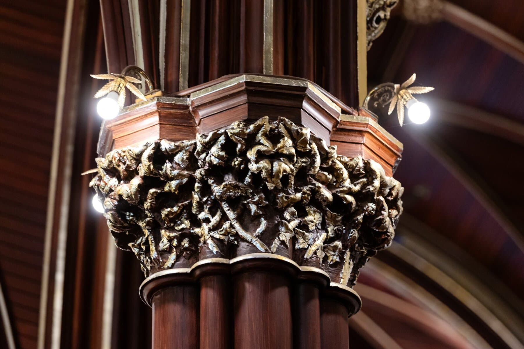 Wedding At the Transfiguration of the Lord Parish 12 Close-up of a carved column capital with ornate leaf designs, perfect for a Wedding at the Church of the Transfiguration of the Lord.