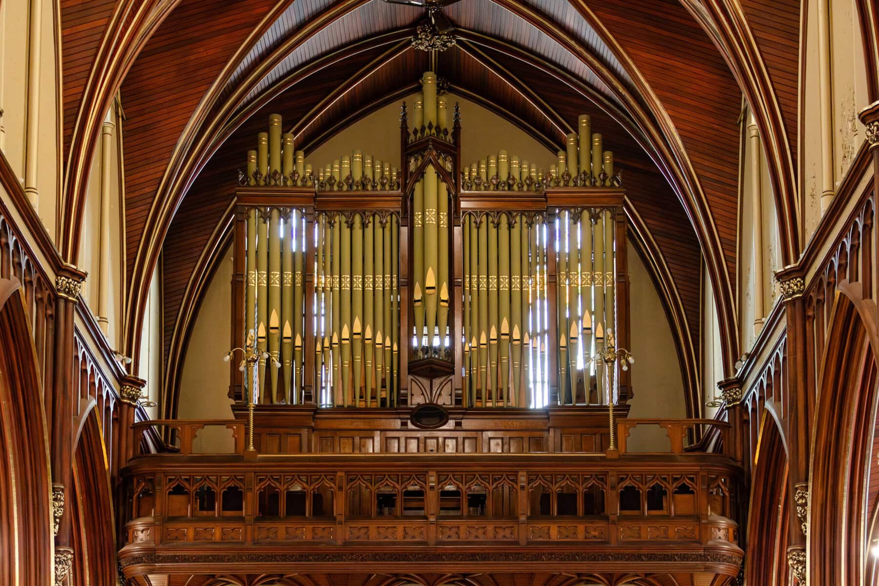 Wedding At the Transfiguration of the Lord Parish 13 Large pipe organ with vertical pipes and woodwork, gracing a vaulted church—ideal for a Transfiguration of the Lord wedding ceremony.