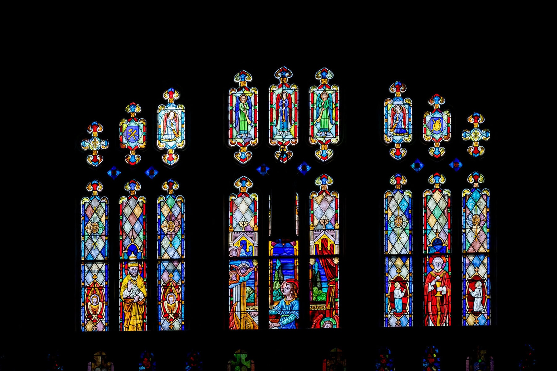 Wedding At Santo Christo Parish in Fall River 15 Stained glass windows at Santo Christo Parish feature colorful, intricate religious scenes—perfect for a memorable Fall River wedding backdrop.