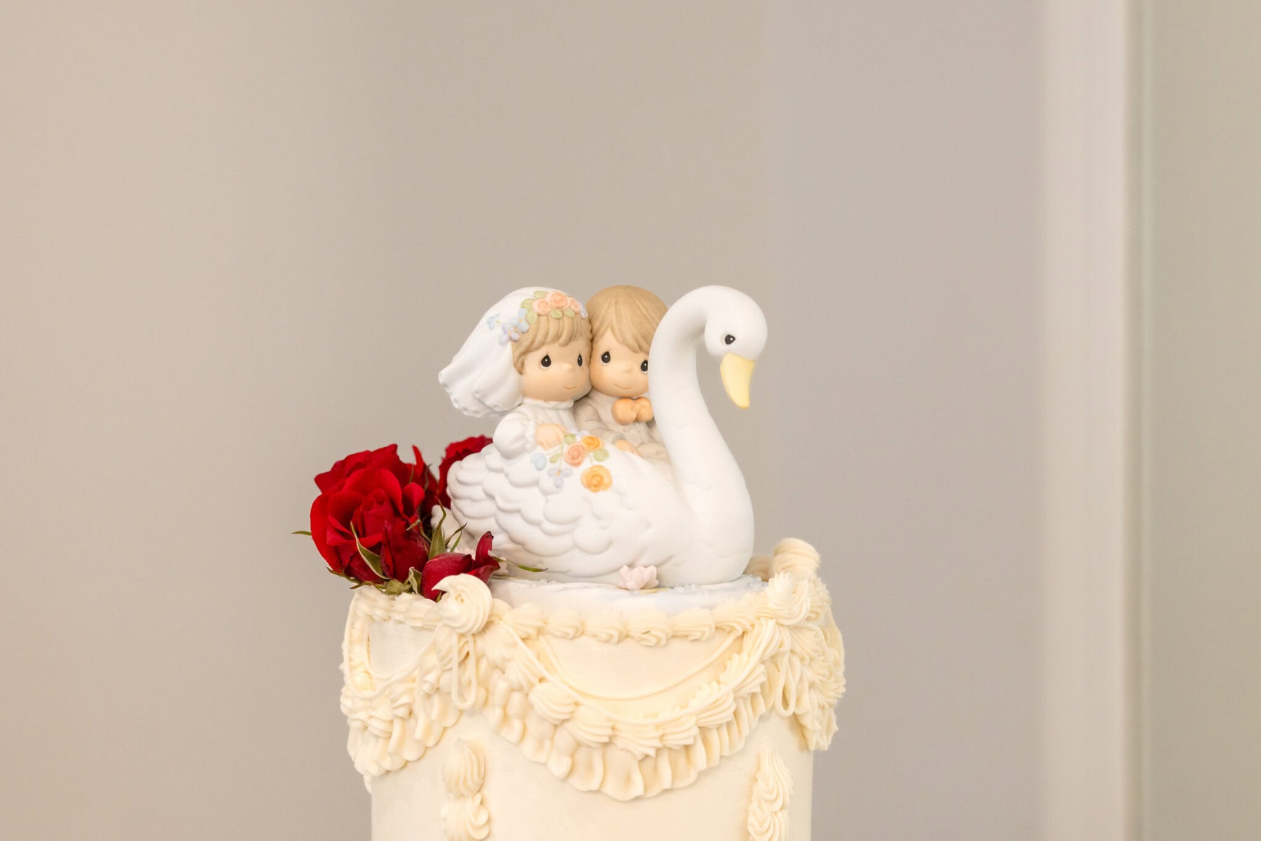 Wedding Reception at The Century House in Acushnet 7 White cake with ornate frosting, red roses, and figurines—perfect for an Acushnet wedding reception at The Century House.