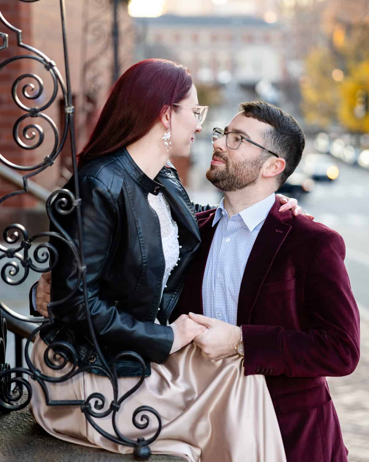 Downtown Providence Engagement Session 8 Brittany and Greg gaze lovingly at each other on a downtown Providence street, beside decorative ironwork during their engagement session.