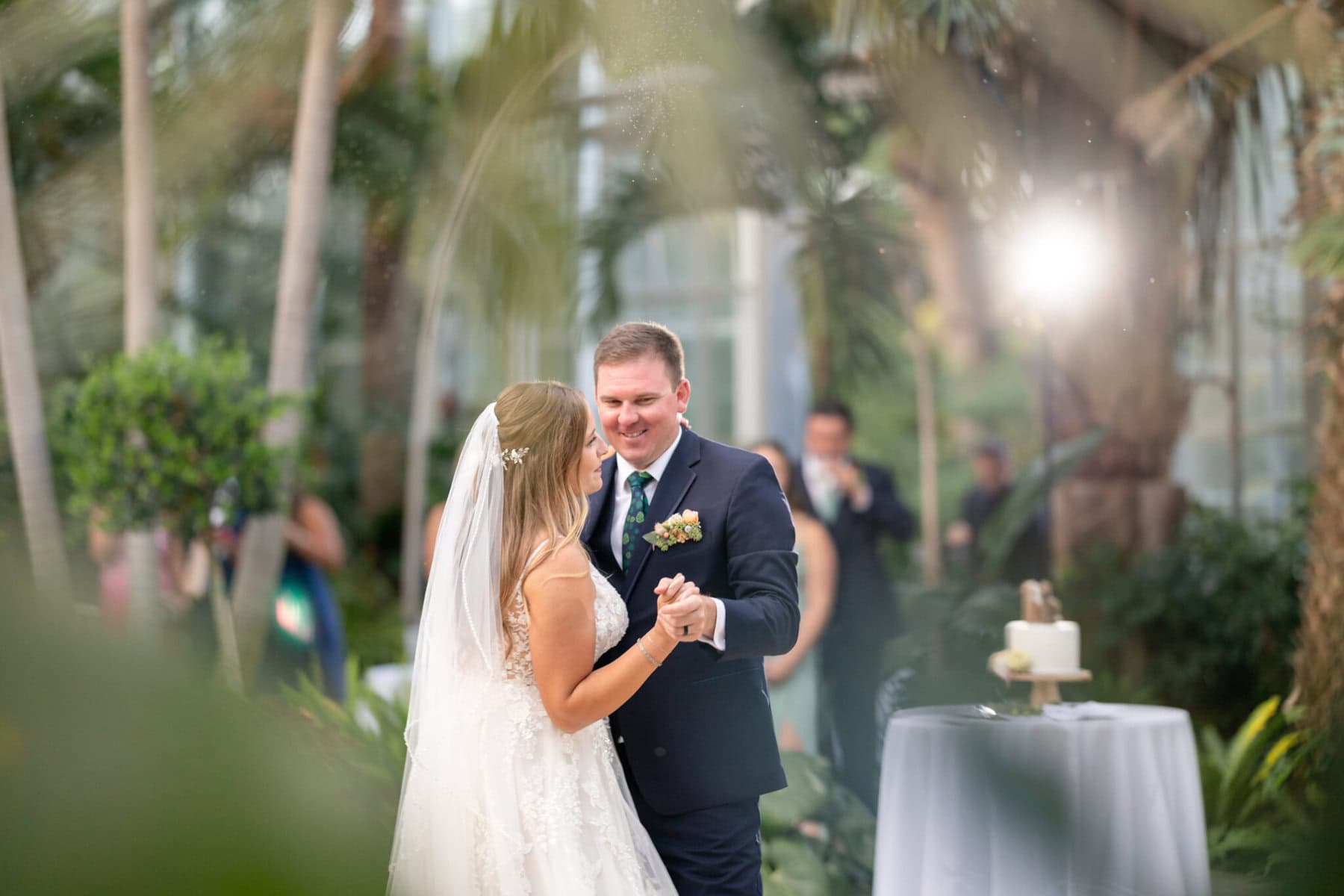 Stunning Wedding at the Roger Williams Botanical Gardens 69 A bride and groom share their first dance at a wedding reception in the lush Roger Williams Botanical Gardens.