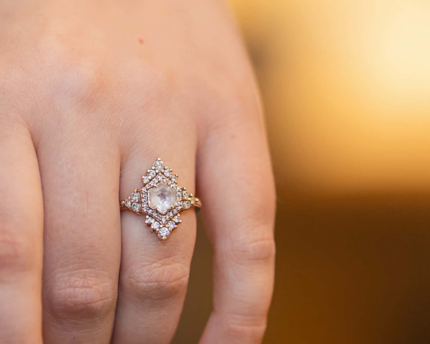 Wedding at the Springfield Elks lodge 4 A close-up of a hand wearing an ornate ring with a central hexagonal clear gemstone and small diamonds, perfect for a Springfield wedding or special event at the Elks Lodge.