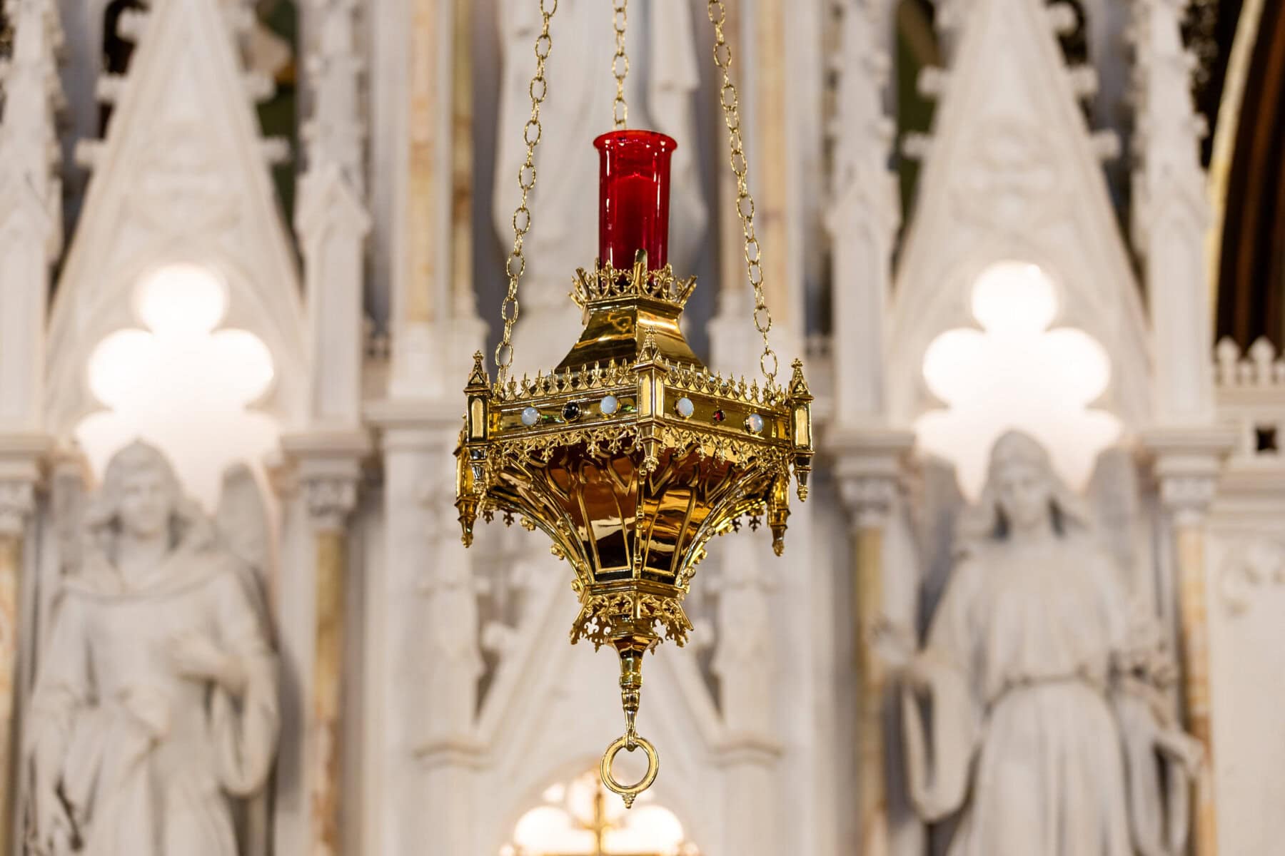 Wedding At St. Mary's Church in North Attleborough 14 A gold sanctuary lamp with a red glass holder hangs at St. Mary's Church, North Attleborough, in front of a white ornate altar.