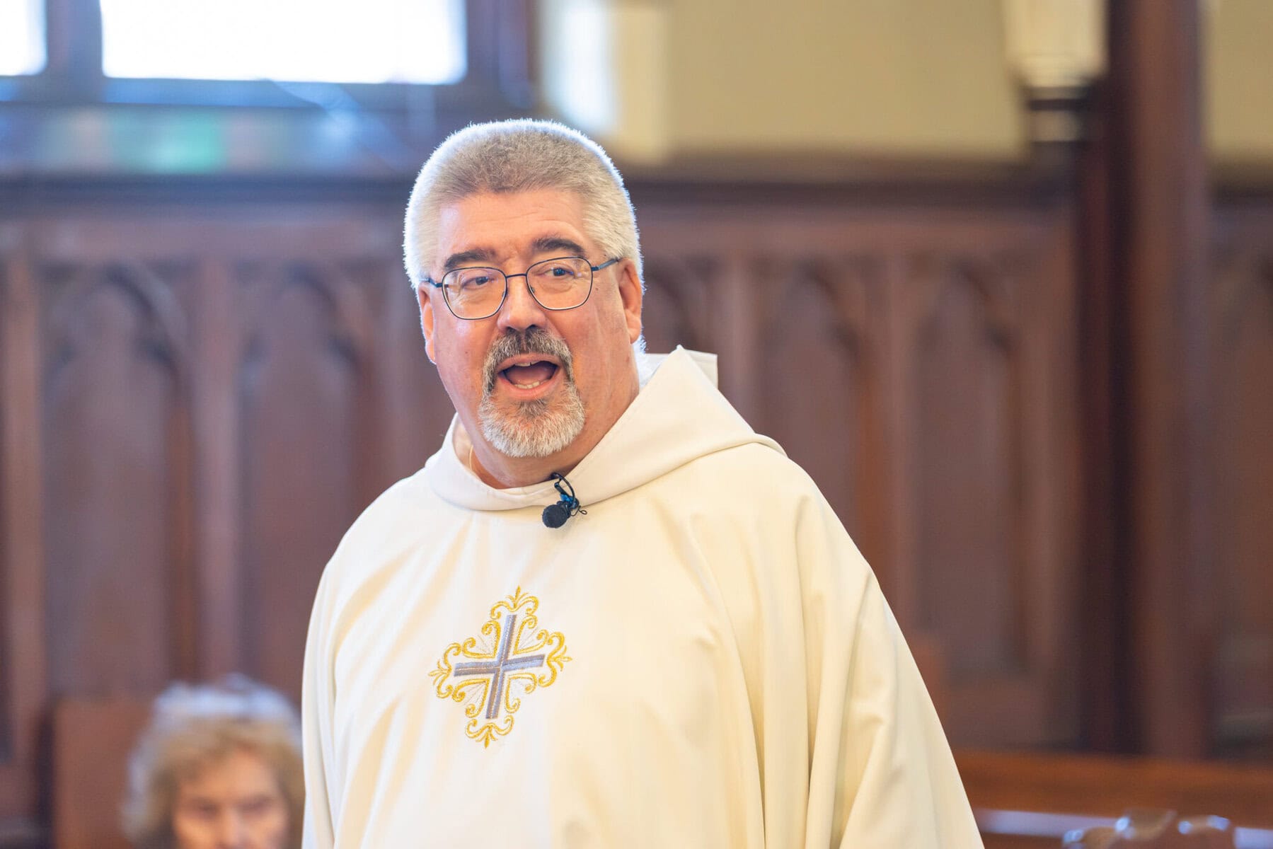 Wedding At St. Mary's Church in North Attleborough 22 A man in a white robe stands outside St. Mary's Church in North Attleborough.